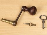 two keys and a hammer sitting on a table