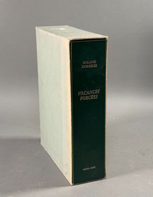 an old book sitting on top of a table next to a white box