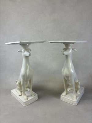 pair of white marble dogs on pedestals with a marble top