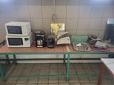 a table with a microwave, toaster, toaster, toaster, and toaster ovens on it