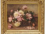 tableau représentant des fleurs roses et blanches, dans un cadre doré, posé sur une table