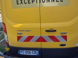 a yellow van that is parked on the side of the road