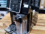 a coffee machine that is sitting on a wooden table