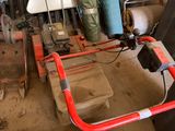 une photo d'une charrette rouge et blanche dans un garage