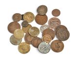 a pile of old coins on a white surface
