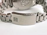 a close up of a watch on a white surface