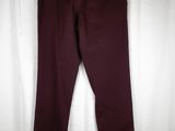 a pair of maroon pants hanging on a white curtain