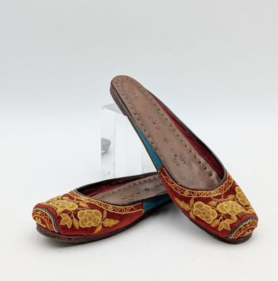 pair of women ' s red and gold slippers with floral design