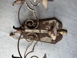 a metal object on a table with a lamp on it
