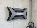a wall mounted tv mounted on the wall in a bathroom