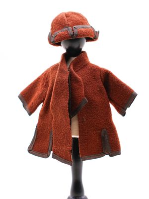 un manteau marron et un chapeau posés sur un mannequin, sur fond blanc