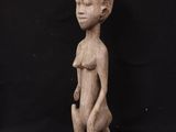 a wooden statue of a woman holding a baby in her arms