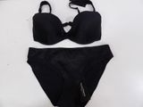 a close up of a black bikinisuit on a white surface