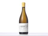 a bottle of white wine sitting on top of a table