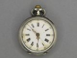 a silver pocket watch with roman numerals on the face