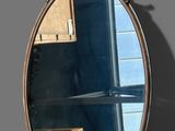 a mirror that has a reflection of a building in it