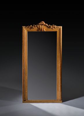 an antique gold framed mirror on a black background