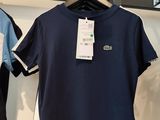 two shirts hanging on a rack in a clothing store
