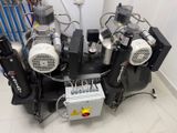 four air compressors sitting on top of each other in a room