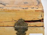 a small wooden box with a metal latch on it