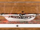 a glass display case with a bowl inside of it