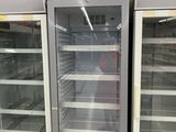 two empty refrigerators that are in a store