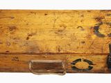 an old wooden box with a handle on it