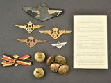 several military badges and a letter are laying on a table