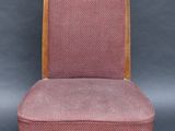 a pink chair with wooden legs and a pink upholstered seat