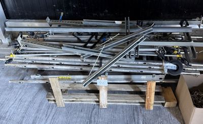 a pile of metal pipes on a pallet in a warehouse