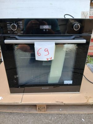 a black oven sitting on top of a cardboard box