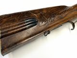 a close up of a rifle on a white surface