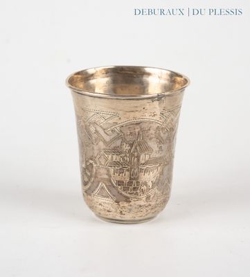 a silver cup with a design on it on a white surface