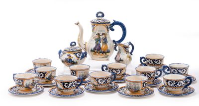 many cups and saucers and a teapot on the table