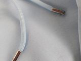 a blue hoodie with a gold bar on it