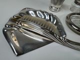 a silver purse with a brush and other items on a table