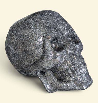 a stone skull that is sitting on a table