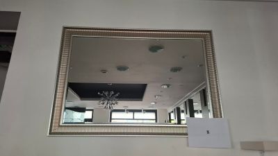 a mirror on the wall above a fireplace in a living room
