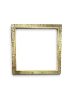a gold picture frame on a white wall with a white background