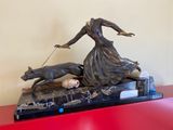 statue of a woman with a dog on a leash on a red table