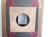 a wooden box with a hole in it next to a wooden box with a hole in it