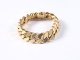 a close up of a gold ring on a white surface