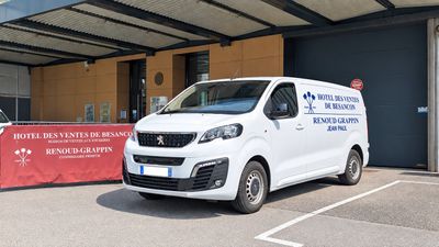 a white van that is parked in front of a building