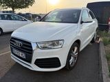 the white audi q3 is parked in a parking lot