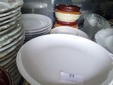 a lot of plates and bowls on the table