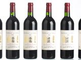 six bottles of red wine are lined up in a row