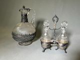 un vase en argent et en verre et une carafe en argent et en verre posés sur une table