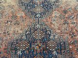 a large antique persian rug with a blue and red design