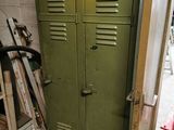 a green locker in the corner of a room next to a bike