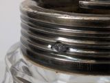 a glass jar with a metal lid on a table